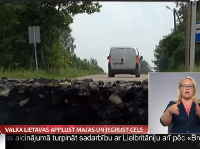 Valkā lietavās applūst mājas un iegrūst ceļš

