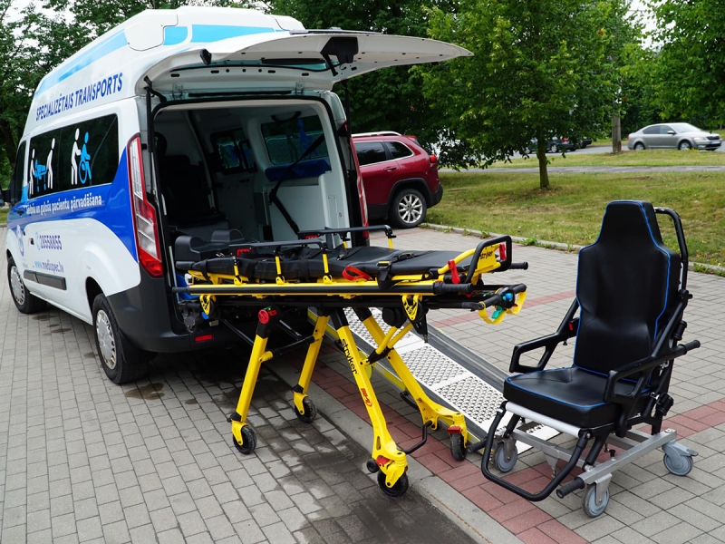 Profesionāls aprīkojums pacienta pārvietošanai — modernās nestuves un specializētais sēdeklis garantē drošu, stabilu un saudzīgu pacienta pārvadāšanu.